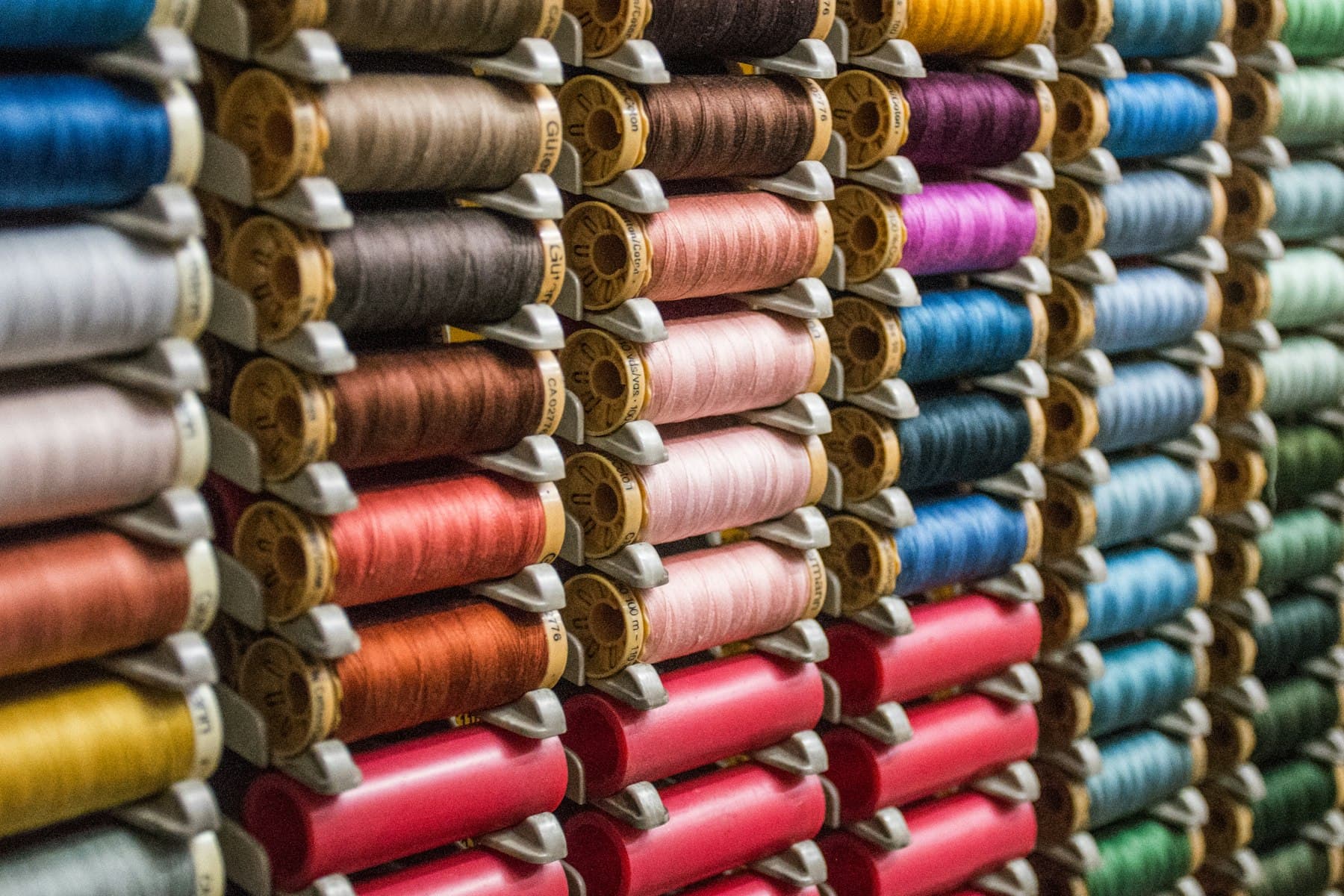 Rows of thread spools in a full range of shades